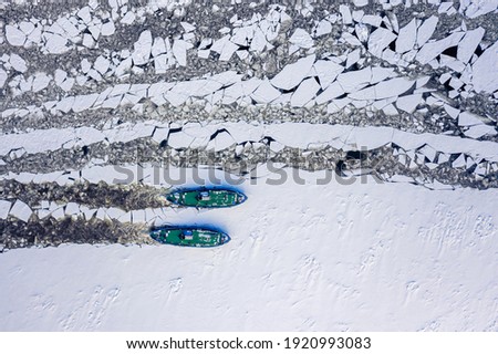 Two icebreakers floating on Vistula crush the ice, 2020-02-18, Poland, aerial view