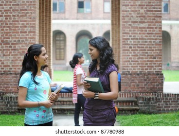 Two Indian College Girls Talking To Each Other.