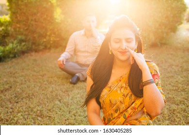 Two Indian People Doing Pranayama Breathing Techniques In The Park Outside