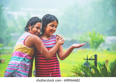 Two Indian/asian Cute Girls Drenched And Playing In Rain