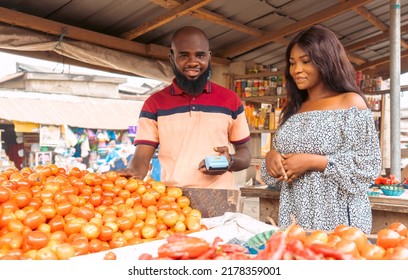 Two Individual In The Nigerian Market Transacting Business Over Vegetable Tomatoes In A Local Area Of Africa