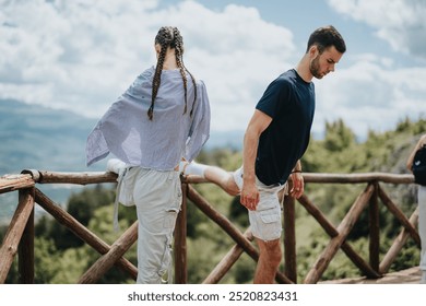 Two individuals engaging in stretching exercises on a wooden deck with beautiful mountain scenery in the background. - Powered by Shutterstock