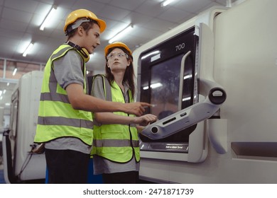 Two industrial engineer operating modern technology CNC machine in metalwork manufacturing. Caucasian factory workers control automated cutter processing machine for metalwork steel cut precision tool - Powered by Shutterstock