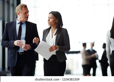 Two Intercultural Colleagues In Formalwear Having Discussion Of Possible Working Questions Before Business Event