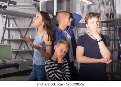 Two Interested Teen Boys With Their Parents Trying To Get Out Of Closed Space Of Escape Room Stylized Under Abandoned Nuclear Bunker, Contemplating Solving Conundrums..