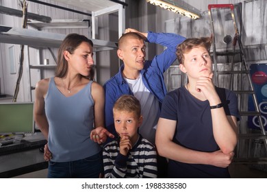 Two Interested Teen Boys With Their Parents Trying To Get Out Of Closed Space Of Escape Room Stylized Under Abandoned Nuclear Bunker, Contemplating Solving Conundrums..