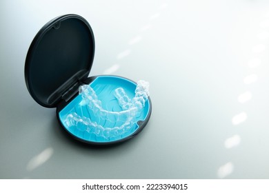 Two invisible dental aligners in the personal box. Orthodontic plastic transparent braces for teeth straightening  - Shutterstock ID 2223394015