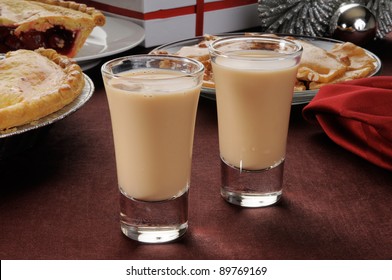 Two Irish Cream Shooters In Shot Glasses With Christmas Candies And Pies