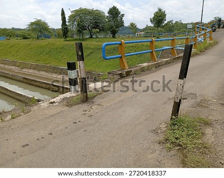 two iron bars on the left and right side of the road to block large trucks