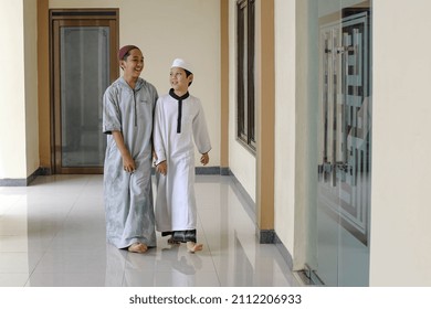 Two Islamic boarding school students are walking and talking each other around the mosque - Powered by Shutterstock