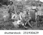 Two Italian soldiers with four wounded barefoot Ethiopian POWs. Italo-Ethiopian War, 1935-36.