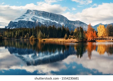 Two Jack lake with snow mountain Autumn foliage and water reflection in Banff National Park in Canada.