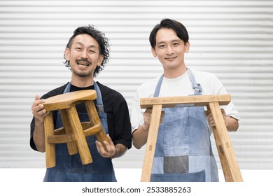 Two Japanese men who cut, shave and make things from DIY wood. Furniture craftsmen. Camera view. Images of recycling, carpentry and woodworking. - Powered by Shutterstock