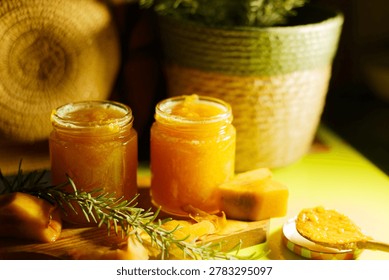 Two Jars Pumpkin Jam On Wooden Board, Rosemary Garnish And Pumpkin Chunks, Warm Golden Light, Woven Basket