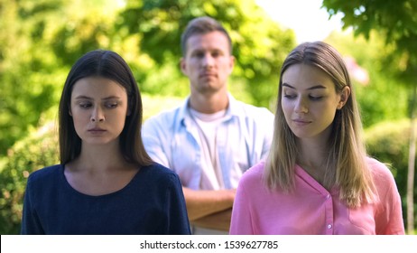 Two Jealousy Women Looking Each Other, Man On Background, Love Triangle Conflict