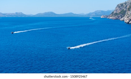 Two Jet Skis Move Around The Bay Of Pollensa In Majorca