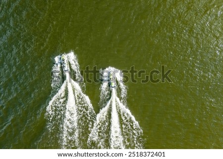 Similar – Image, Stock Photo Aerial view capturing the complex network of ridges and valleys in Utah’s desert, highlighted by contrasting golden paths