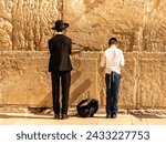 two Jews pray at the Western Wall