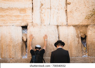 Two Jews Praying At The Western Wall In Jerusalem