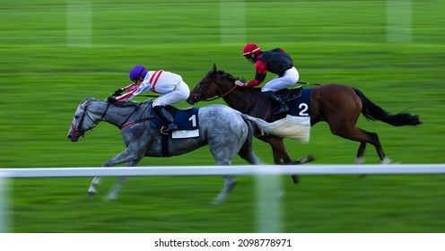 Two jockeys during horse races on his horses going towards finish line. Traditional European sport.