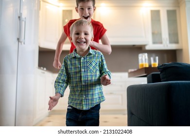 Two Joyous Boys Rushing Around The House