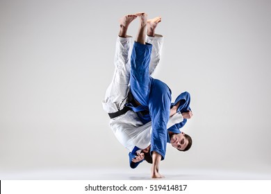 The two judokas fighters fighting men - Powered by Shutterstock