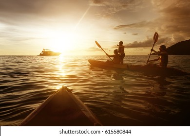 Two Kayaks Swimming At In Sunset Sea. Travel And Family Life Concept