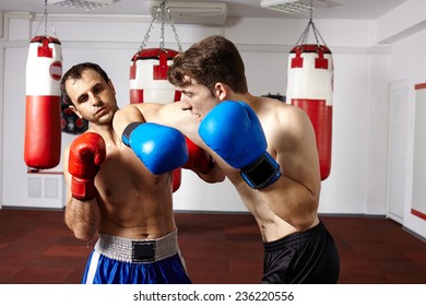 Two Kickbox Or Muay Thai Fighters Sparring In The Gym