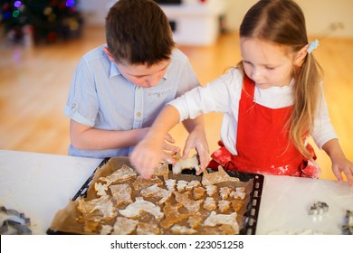 Two Kids Baking Gingerbread Cookies At Home On Christmas Eve