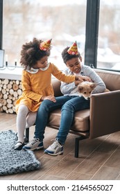 Two Kids In Bday Hats Celerating Puppys Birthday