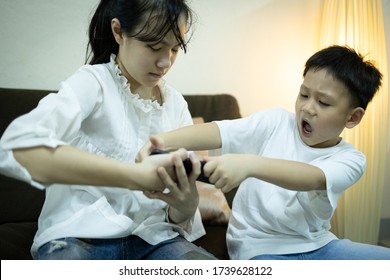 Two Kids Boy And Child Girl Fighting For Smartphone,sibling Pulling Mobile Phone One Another,shout And Quarrel,children Arguing For Playing With Phone At Home,aggressive,technology,internet Addiction