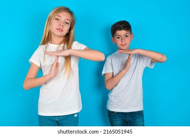 Two Kids Boy And Girl Standing Over Blue Background Feels Tired And Bored, Making A Timeout Gesture, Needs To Stop Because Of Work Stress, Time Concept.