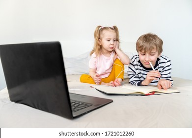 Two Kids Boy And Girl Studying At Home Using Laptop And Headphones