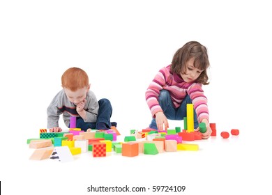 Two Kids Building Block Towers. Isolated On White With Shadows