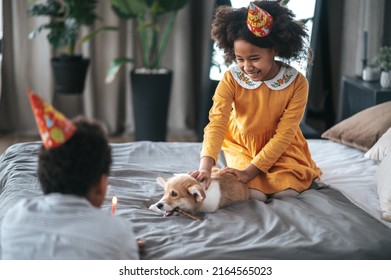 Two Kids Celebrating Puppys Bday And Offering Him A Pancake