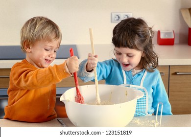 Two Kids Cooking In A Domestic Kitchen