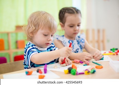 Two Kids Doing Arts And Crafts In Day Care Centre