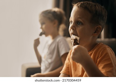 Two Kids Eating Icecream And Watching TV, Brother And Sister, Male And Female Kid Eat Candy