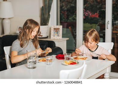 Two Kids Eating Lasagna For Lunch, Healthy Home Made Meal For Children