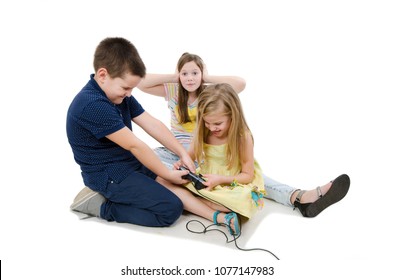 Two Kids Fighting For Video Games. Annoyed Old Sister Covering Her Ears With Her Hands Can Not Listening. Isolated On White Background 