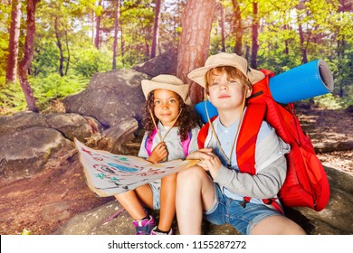 Two Kids In Forest Navigate With Map Treasure Hunt