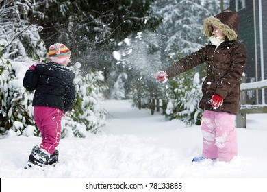 Two Kids Having A Snow Ball Fight