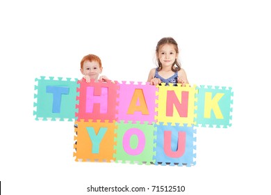 Two Kids Holding Up Sign Saying Thank You. Isolated On White.