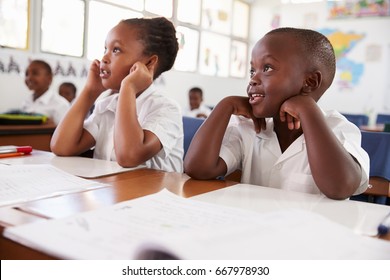 Two Kids Listening During A Lesson At An Elementary School