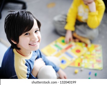 Two Kids Playing A Game Of Cards