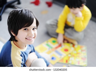 Two Kids Playing A Game Of Cards