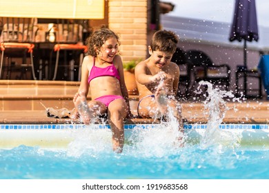 Two Kids Playing On A Poolside