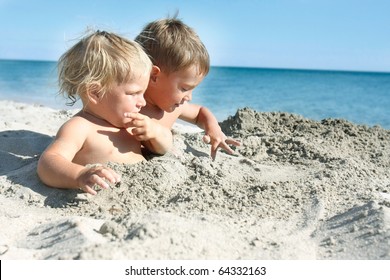 Two Kids Playing On Sand Beach