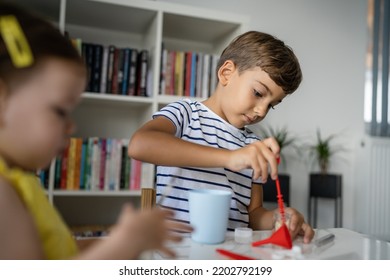 Two Kids Playing With Toys At Home One Boy Preschooler With His Little Sister Baby Girl Making Experiments Childhood Growing Up Concept