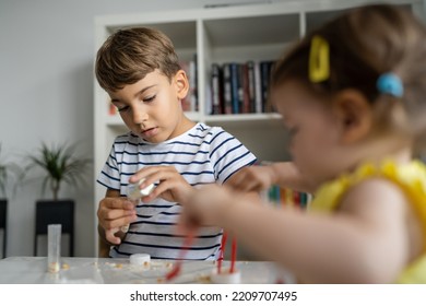 Two Kids Playing With Toys At Home One Boy Preschooler With His Little Sister Baby Girl Making Experiments Childhood Growing Up Concept